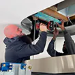 A team member securing an island rangehood