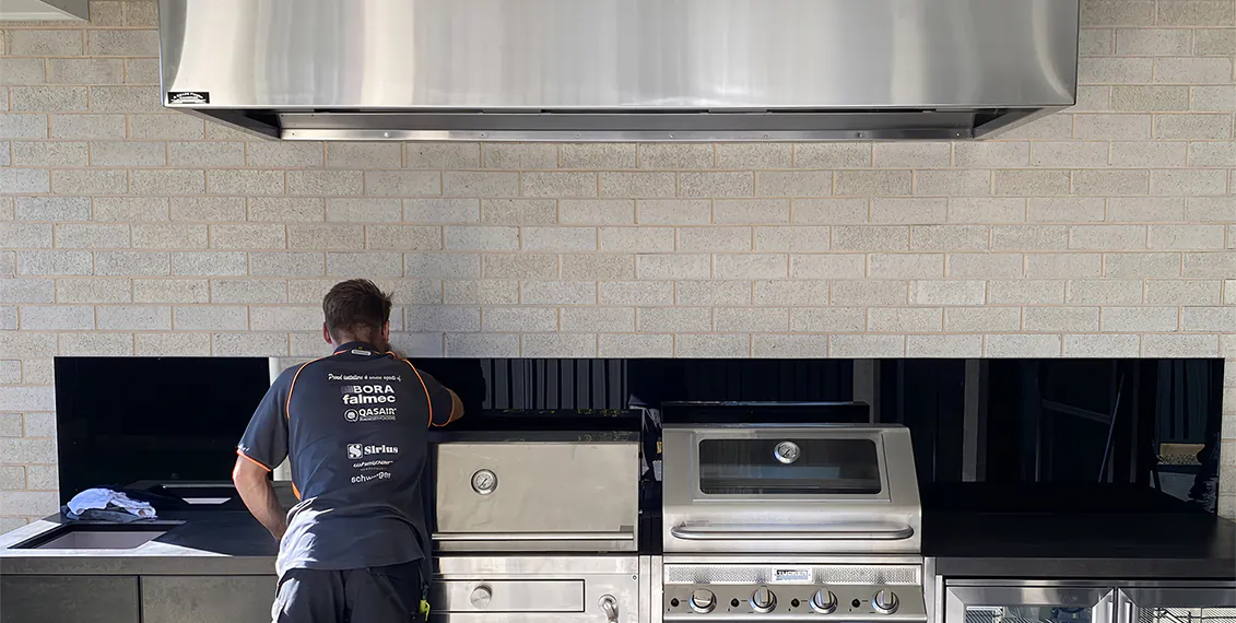 Our electrician putting the finishing touches on a rangehood installation