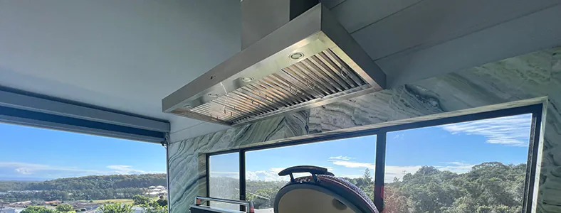 A large new stainless island style rangehood and an alfresco area, providing a perfect blend of functionality and outdoor elegance