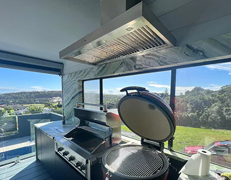 A new stainless island style rangehood and an alfresco area