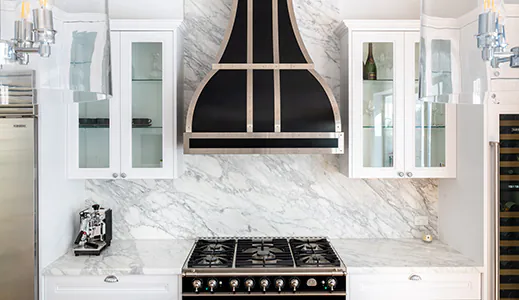 A custom contemporary black rangehood, blending seamlessly with modern kitchen aesthetics
