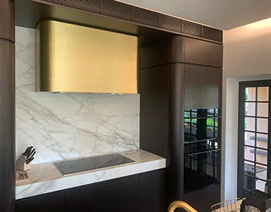 A beautiful golden canopy rangehood, adding elegance to a modern kitchen