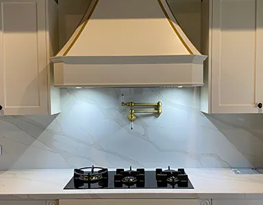 A white custom canopy rangehood in a contemporary kitchen