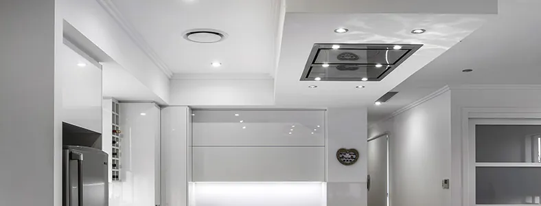 A nice stainless steel ceiling cassette rangehood in a white kitchen, providing a modern and efficient ventilation solution