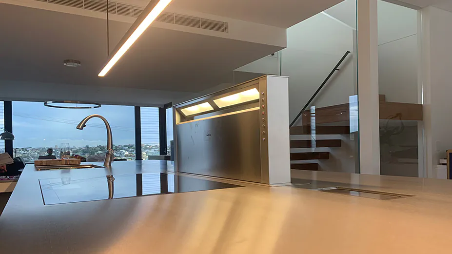 A white Qasair wall-mounted rangehood in a modern kitchen