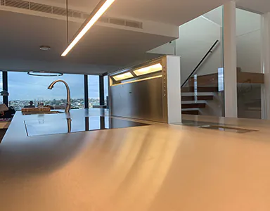 A large downdraft modern rangehood in a beautiful kitchen, providing efficient ventilation with a sleek design
