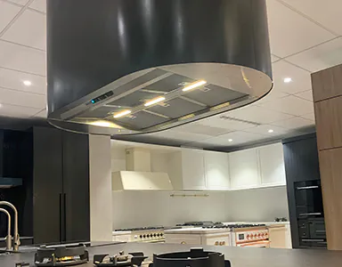 A large powerful island rangehood in a kitchen display, showcasing its robust design and efficient performance