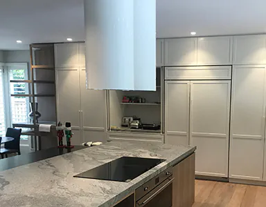 A modern white tubular island rangehood in a spacious kitchen, providing efficient ventilation with a sleek design