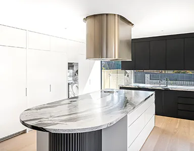 A stunning bronze finished island rangehood in a spacious kitchen, adding a touch of elegance and style