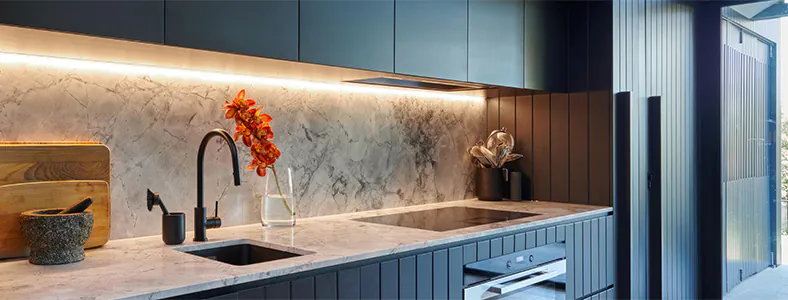 A beautiful new under mount rangehood in a black kitchen, enhancing the modern aesthetic with its sleek design