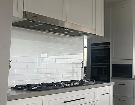 A Qasair under-mount rangehood neatly hidden under a kitchen cabinet
