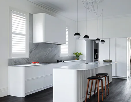 A white Qasair wall-mounted rangehood in a modern kitchen