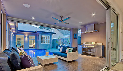 A beautiful stainless wall mounted rangehood in an outdoor living area, providing efficient ventilation and style