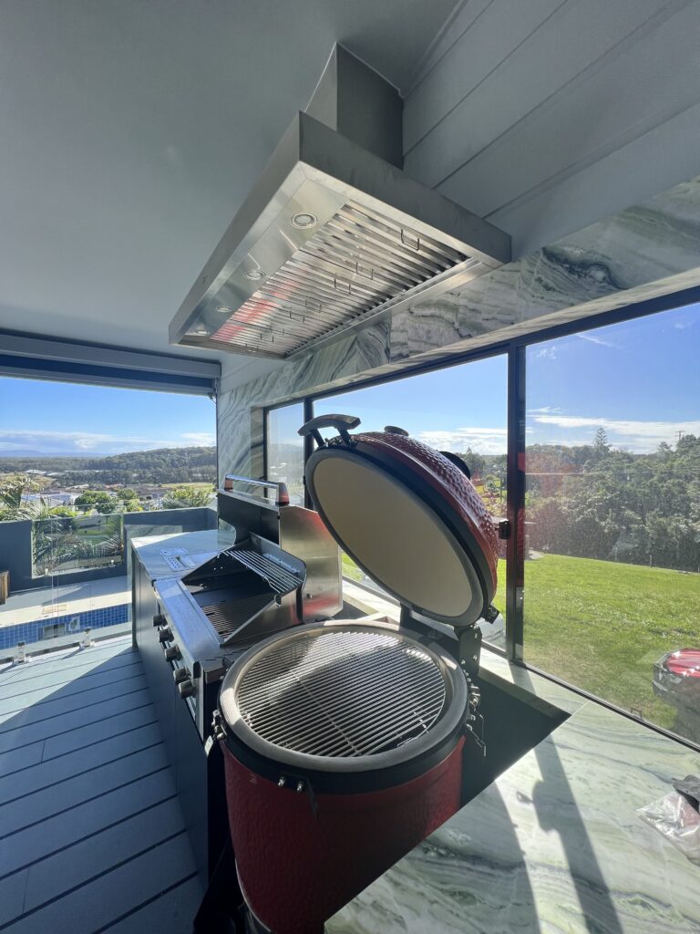 Detailed view from the right of the Schweigen Rangehood highlighting its stainless steel finish.